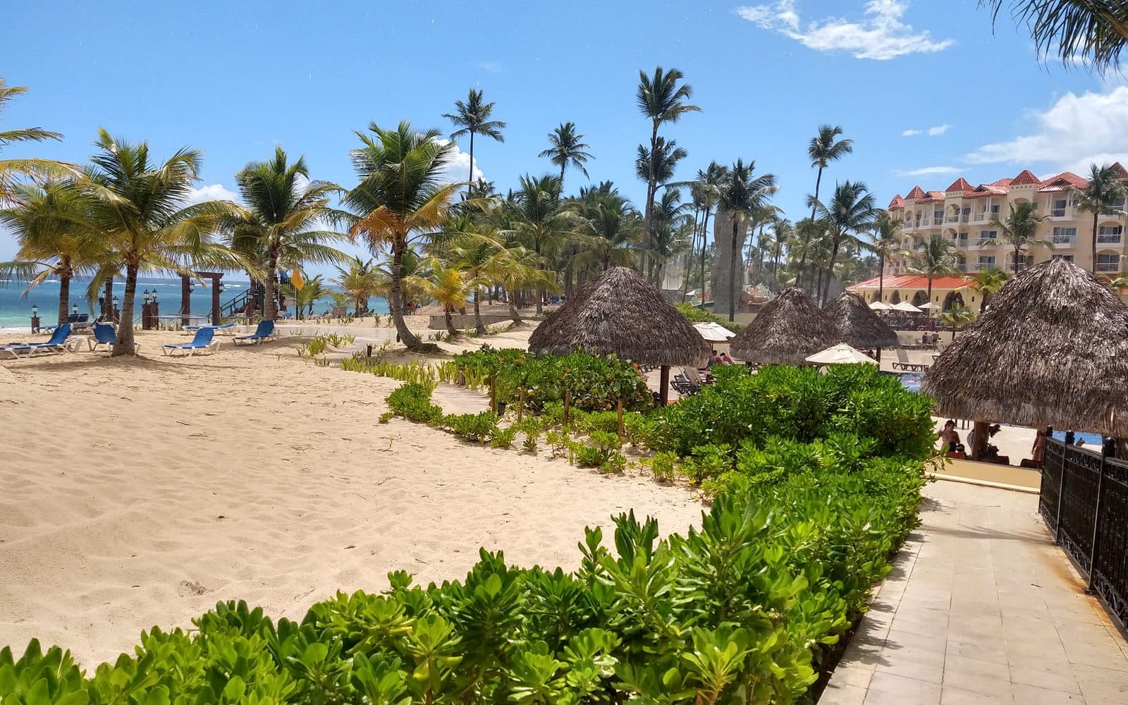 La playa del todo incluido, con las palapas y el hotel al fondo, agosto de 2021